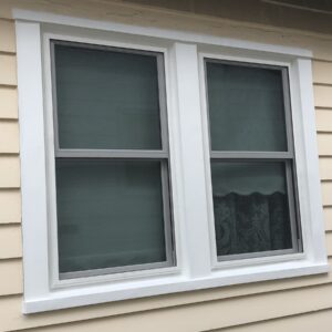 Professional window installation with clean white trim and casing