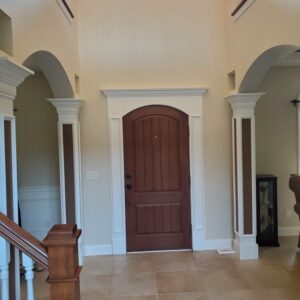 Custom arched entry with architectural detailing and premium door installation