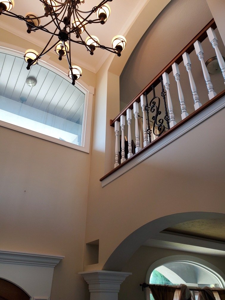 Custom railing & two-story foyer with quality finish details