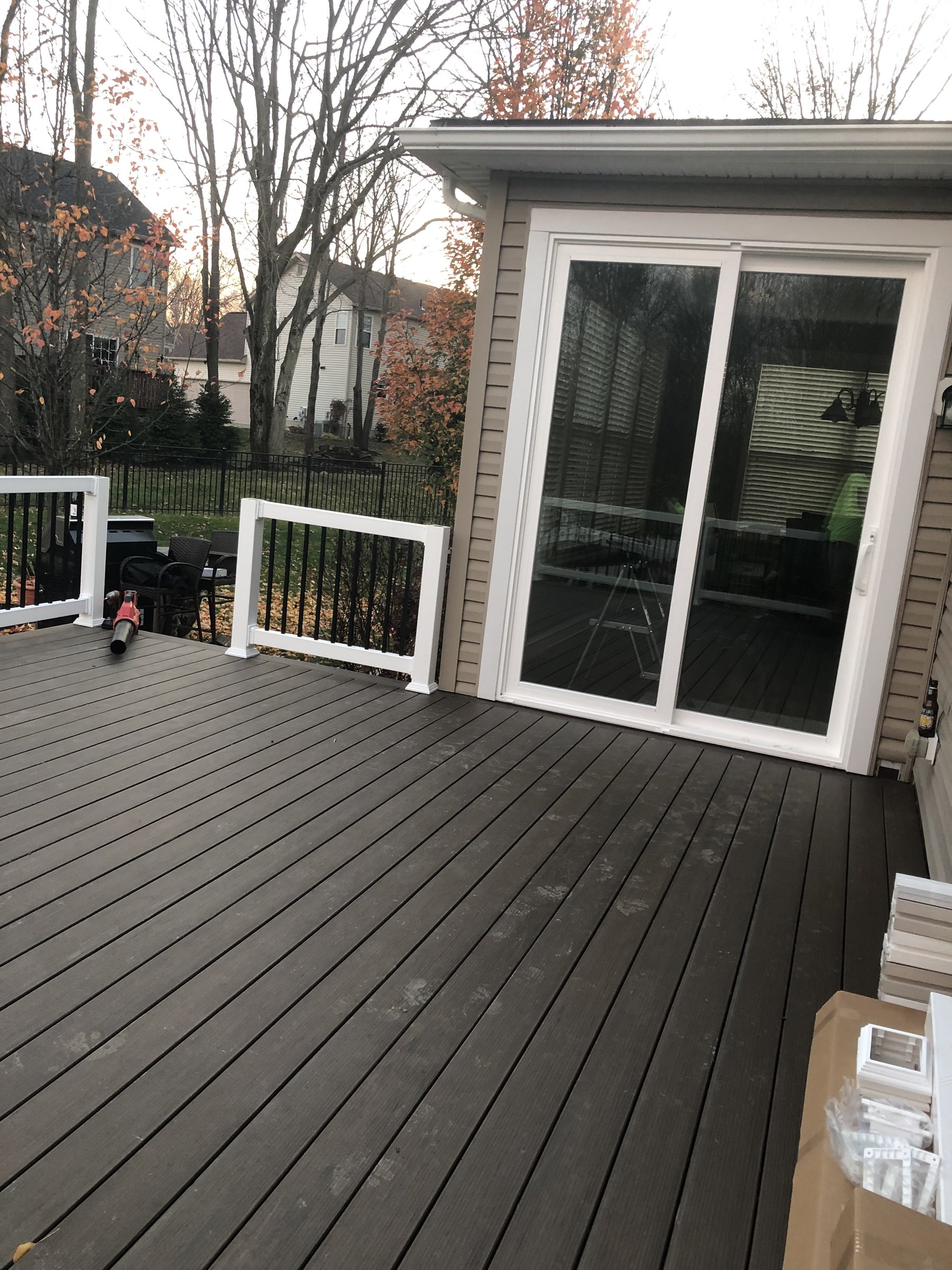 Modern composite deck with white vinyl railing and patio doors